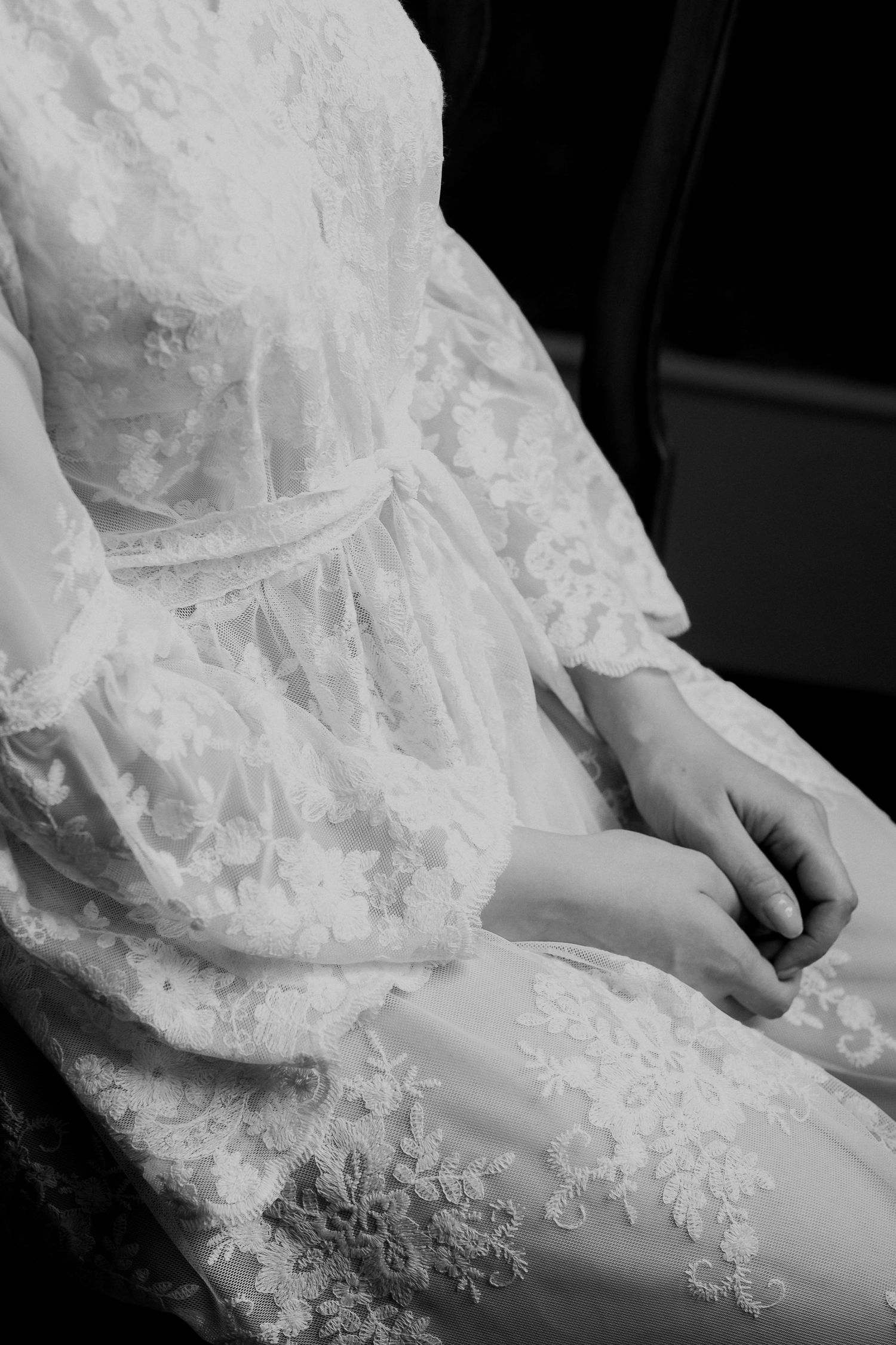Close-up details of delicate white lace on a wedding dress.