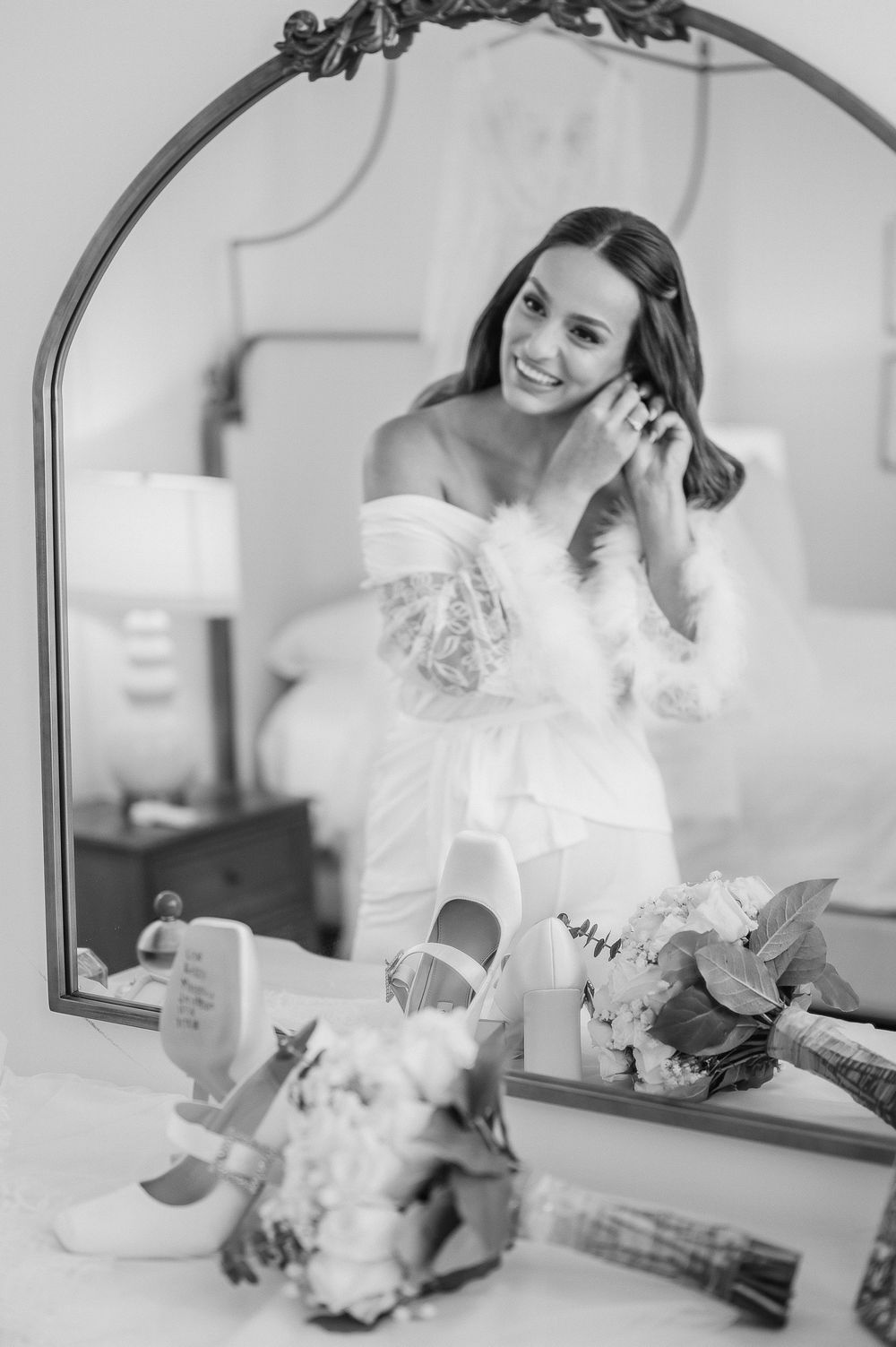 A sequence of black and white photos showing preparations with a white dress and mirror.