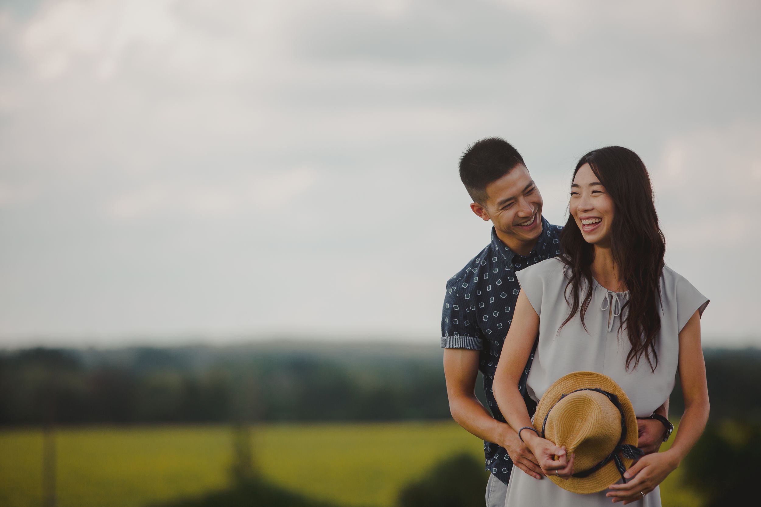 Couple shares romantic moments in nature during outdoor photo session with multiple candid poses.