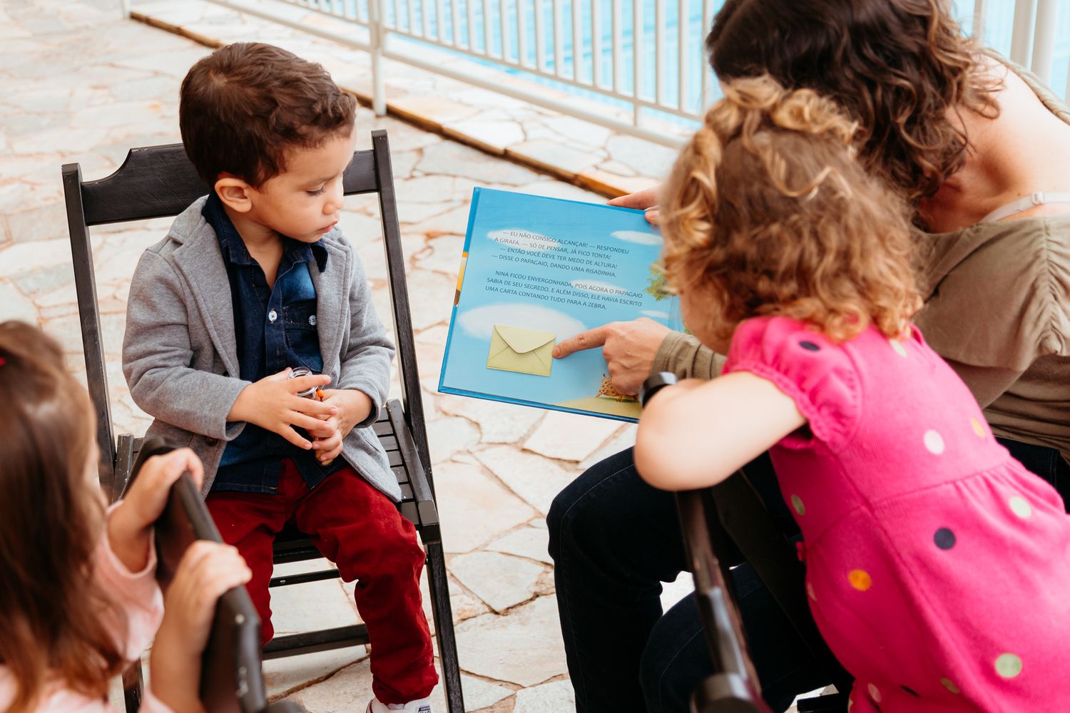 A series of five sequential photos showing a magic trick being performed with playing cards on an outdoor deck.