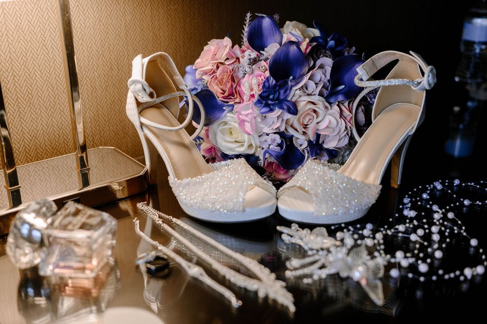 A collection of white and pink baby shoes and accessories arranged in a decorative display.