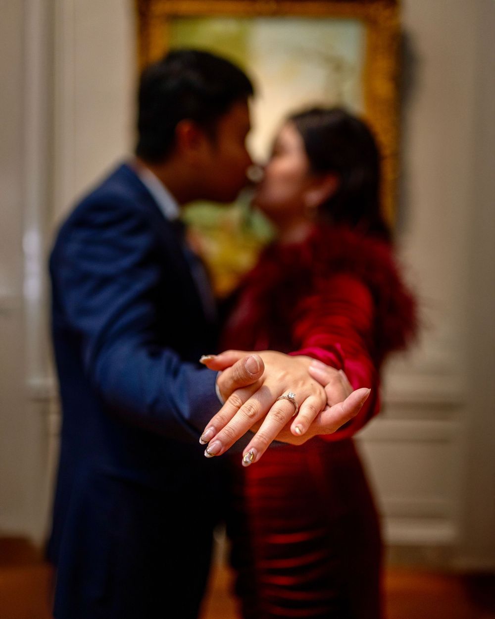 Close-up of hands during an intimate dance moment in an ornate room.