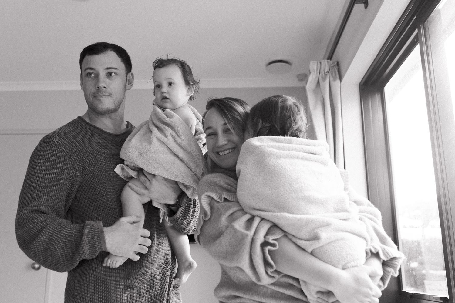 A black and white photo strip showing candid moments and reactions in what appears to be a photo booth.