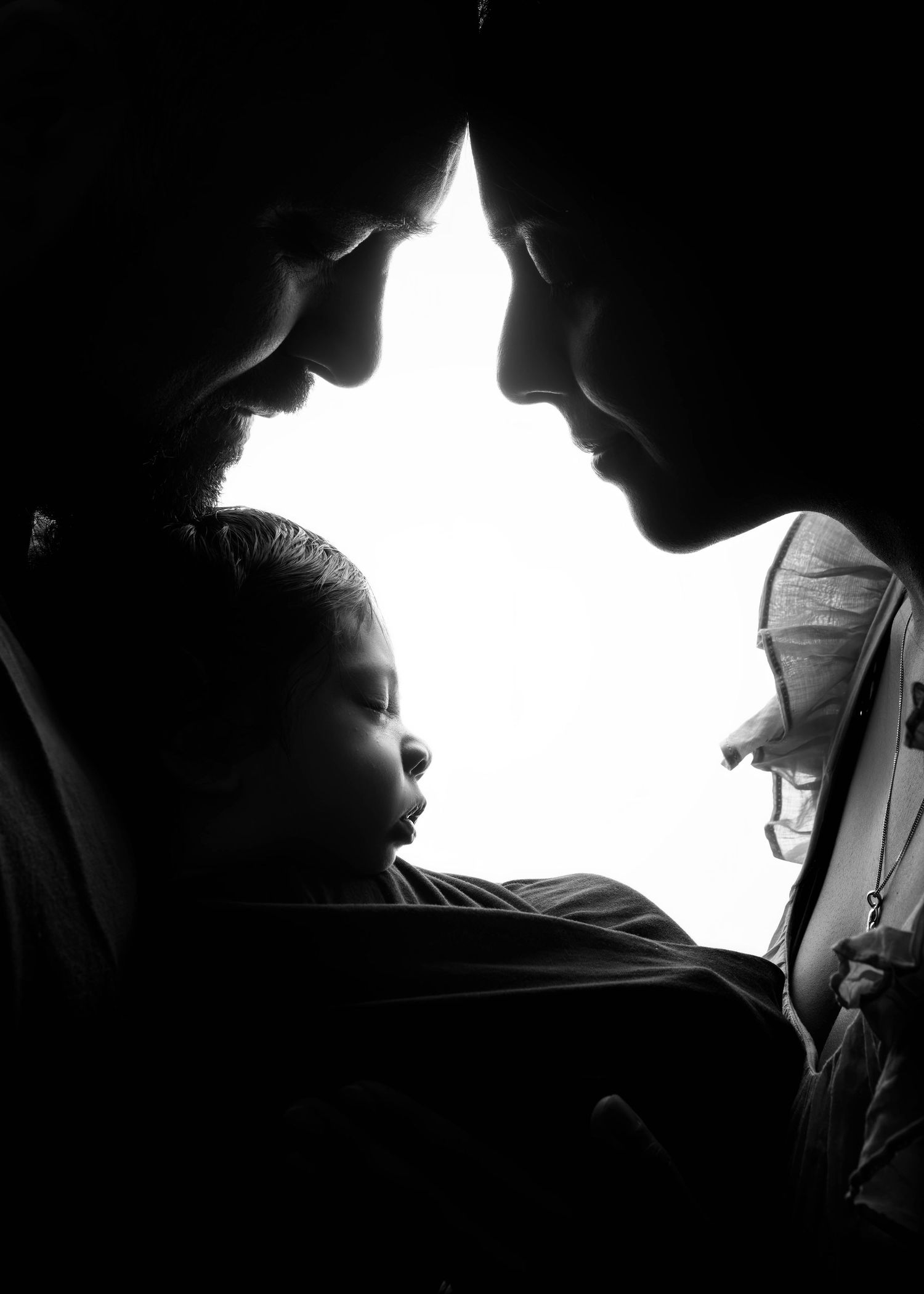 A series of black and white silhouette portraits showing a person in dramatic side lighting against dark backgrounds.