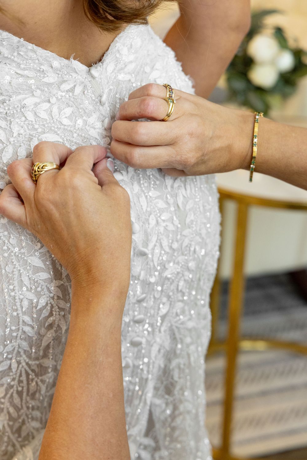 Sequential shots of hands exchanging wedding rings during a ceremony.