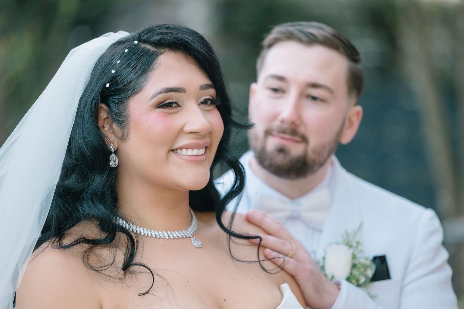 Newlyweds share a romantic moment on the dance floor at their wedding reception while guests celebrate around them.
