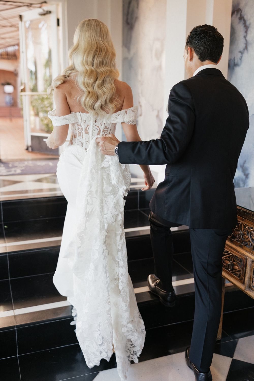 A couple in formal wedding attire plays a piano together in a series of candid shots.