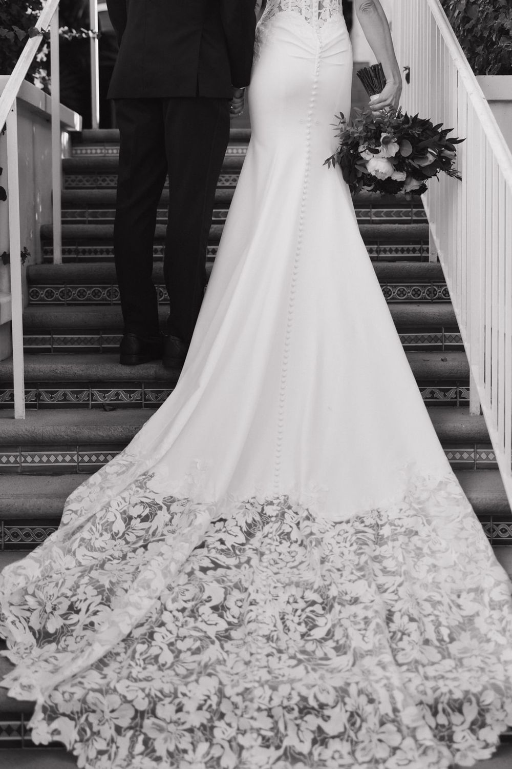 Elegant white wedding dress train with intricate floral embroidery details shown from multiple angles on staircase.