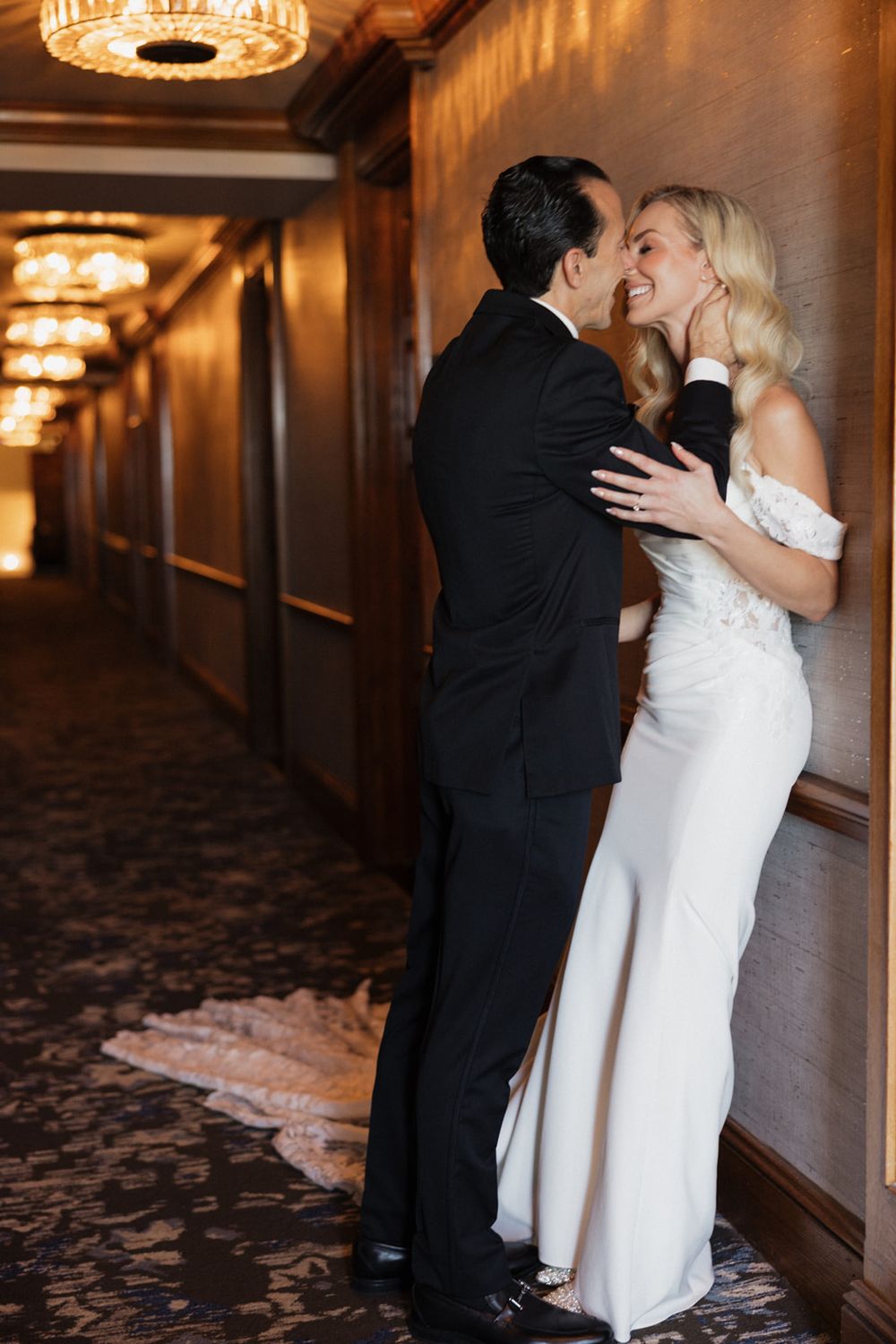 A romantic sequence of wedding photos showing a couple embracing in a dimly lit hotel hallway with elegant chandeliers.