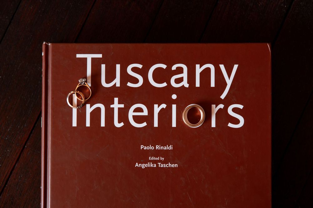 A collection of hardcover interior design and architecture books arranged in a row on a shelf.