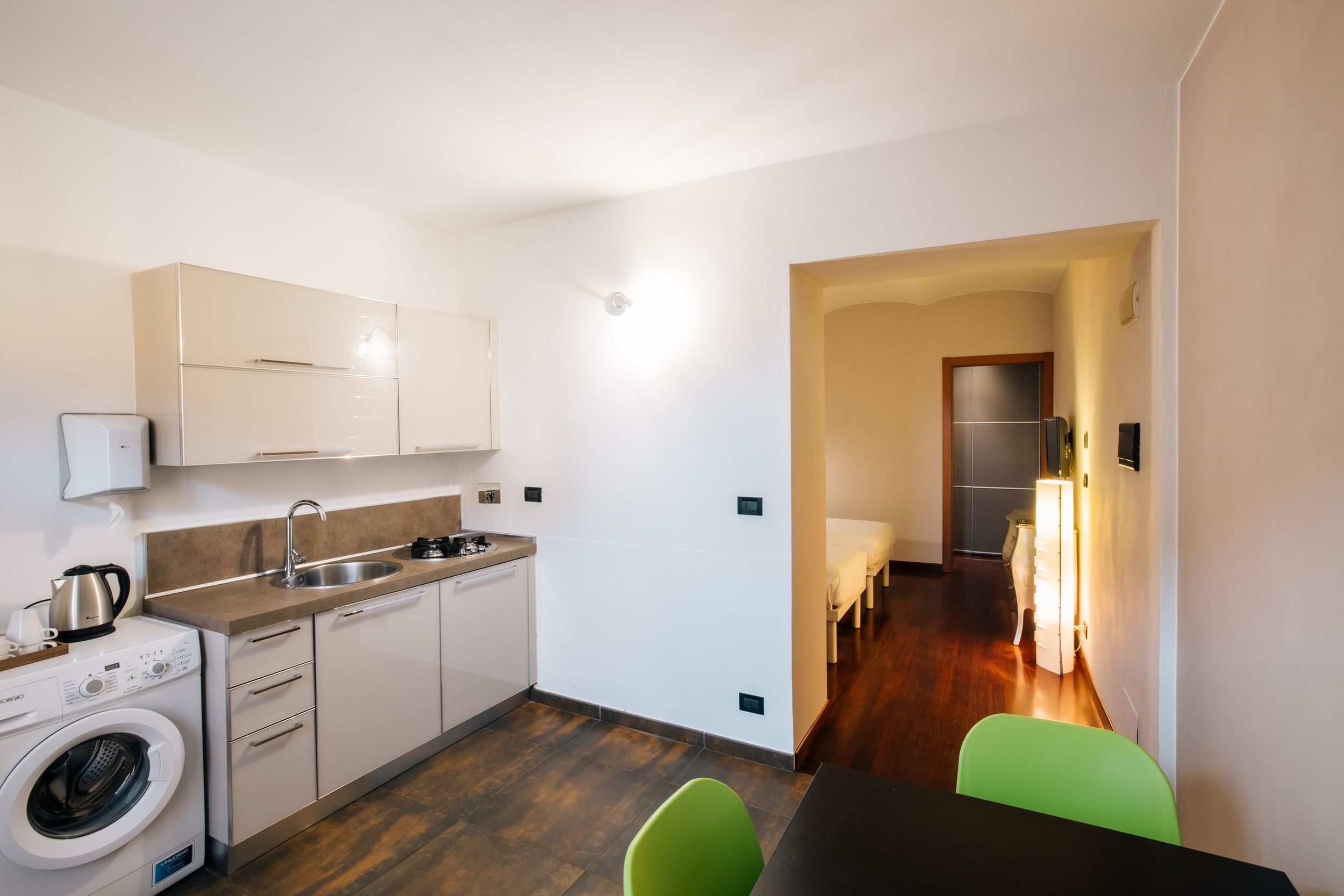 Modern apartment interior collage showing white kitchen, living spaces, and laundry area with contemporary finishes.