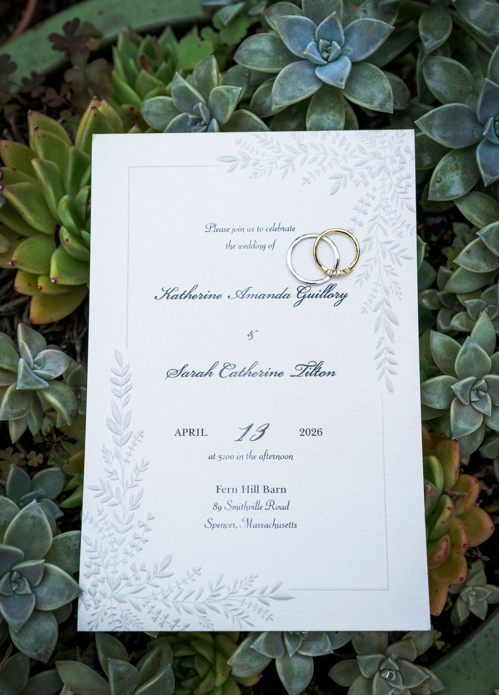 Wedding invitation for Katharine Amanda Guillory and Sarah Catherine Tilton, April 13 2026, Fern Hill Barn, Spencer Massachusetts.