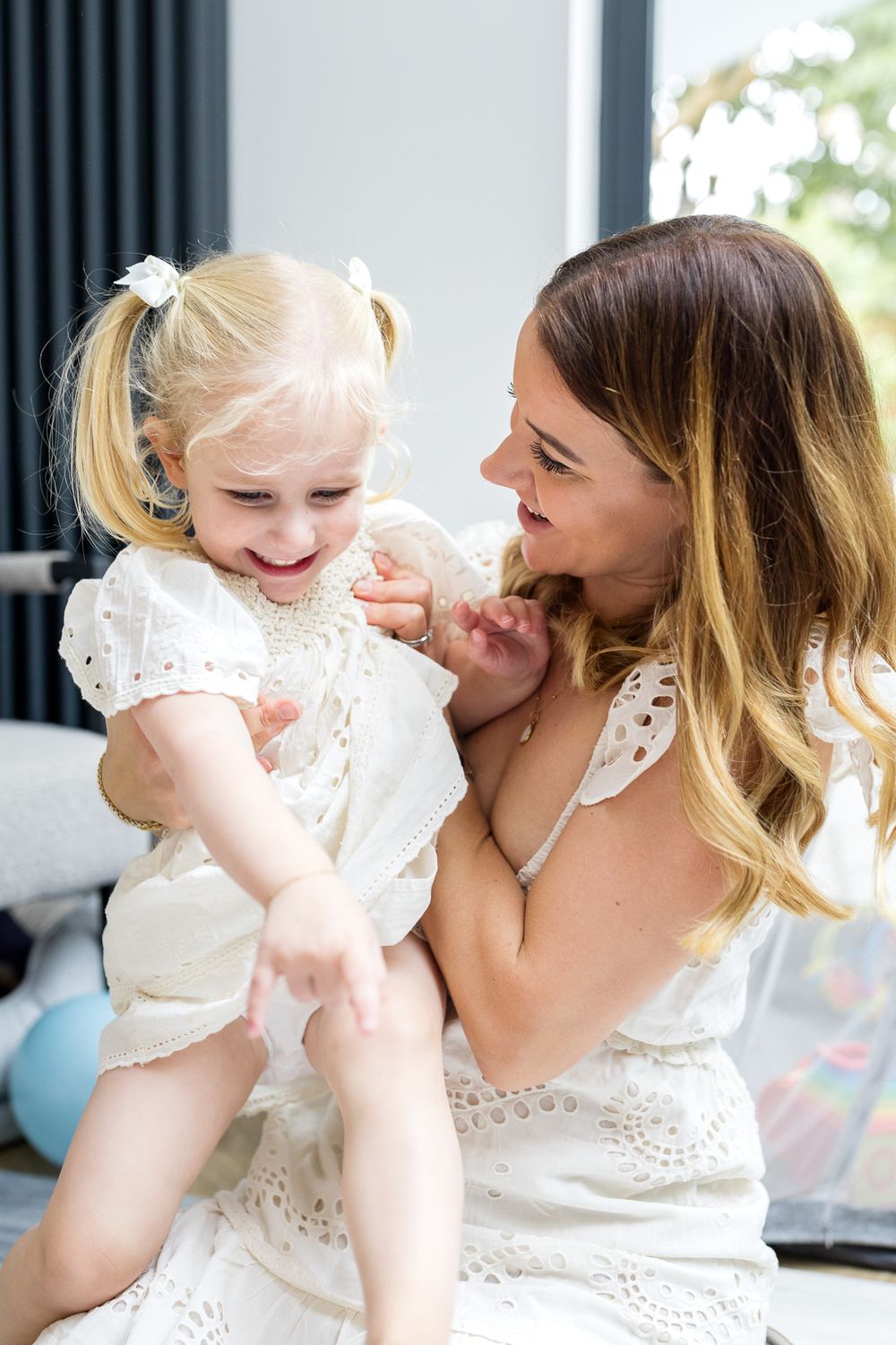 mum laughing with her toddler girl