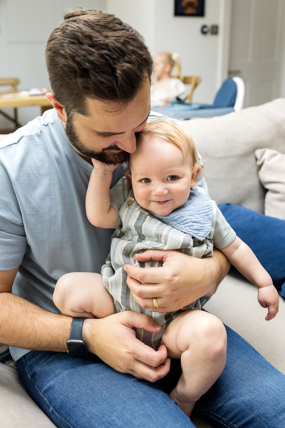 Dad holding his baby boy son on his lap