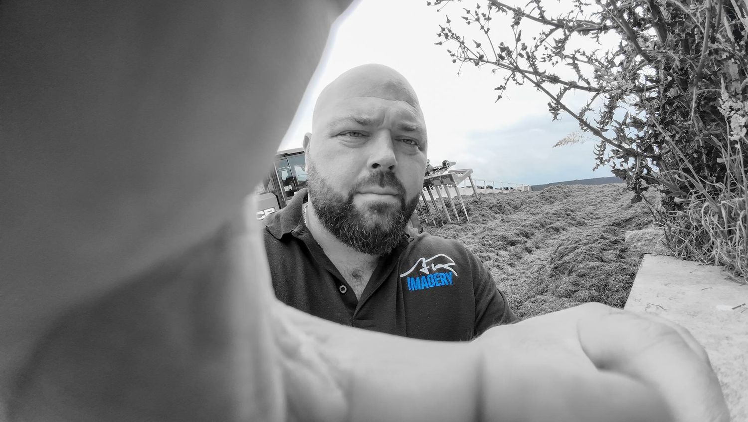 A person takes selfies showing various facial expressions and poses in an outdoor setting.