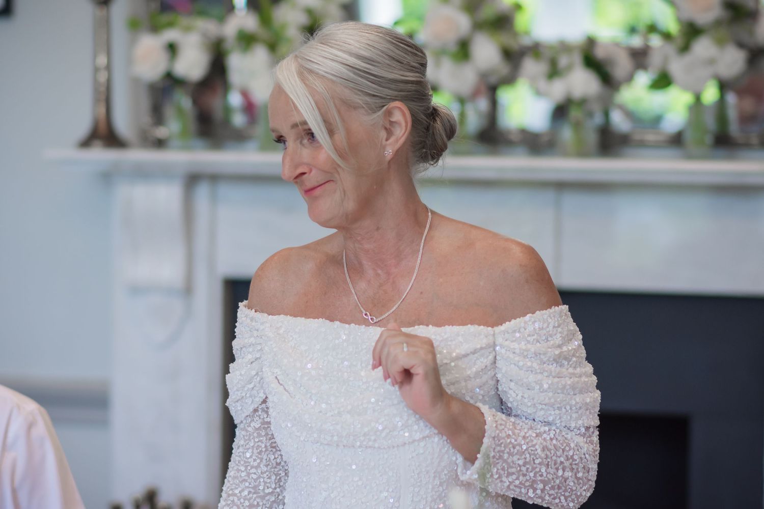A couple shares a tender moment during their wedding celebration in an elegant indoor venue.