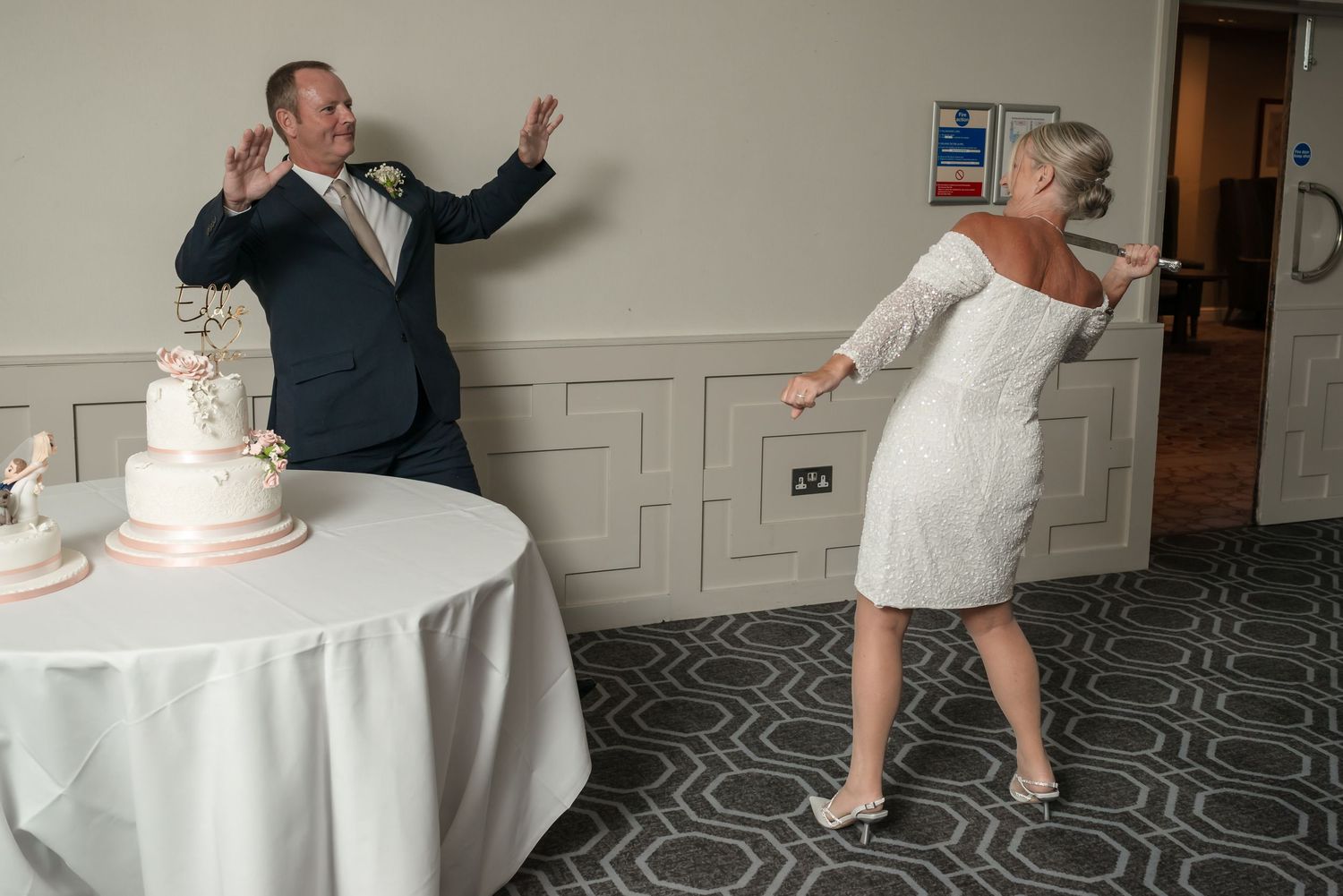 A sequence of playful dance moves at a wedding reception on a patterned carpet floor near a white-clothed table.