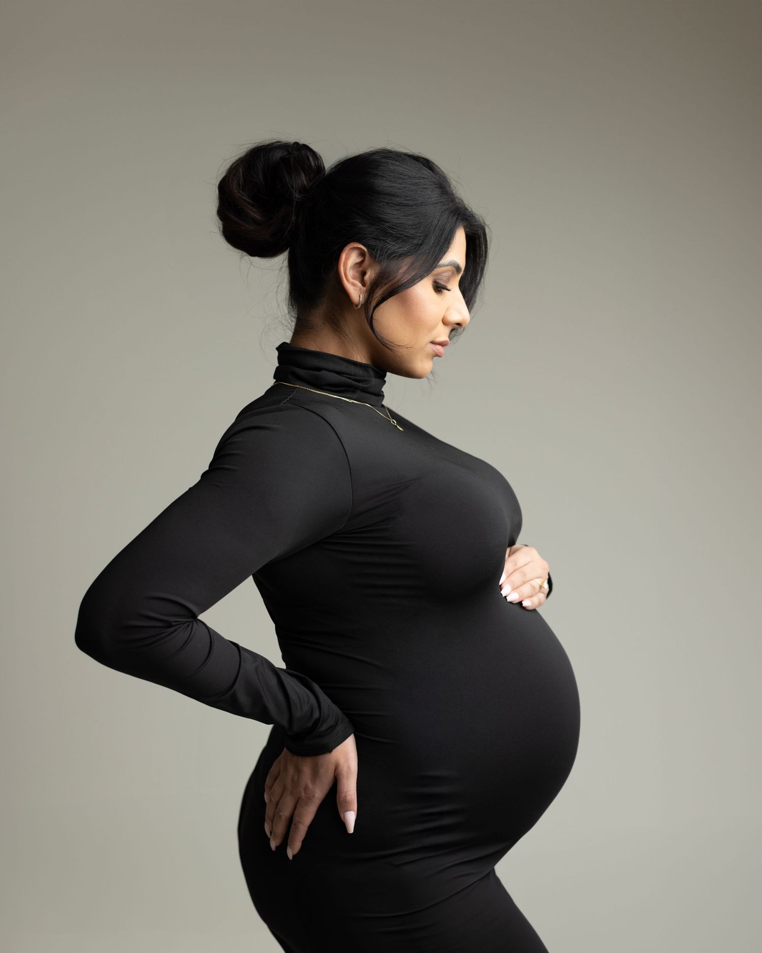 A series of artistic black and white photos showing a figure in black clothing posing against a neutral background.