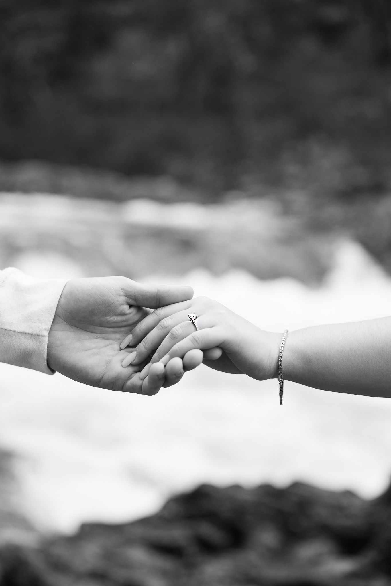 A series of black and white photos showing hands with wedding rings in different poses.
