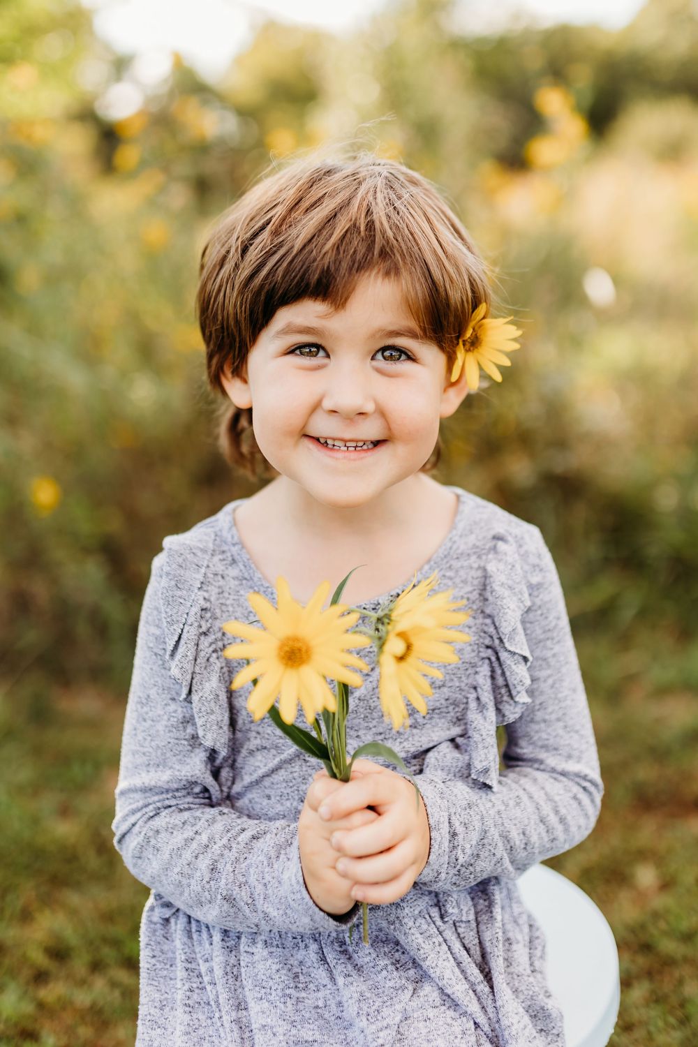 Cute girl posing with flower in Northern Kentucky.