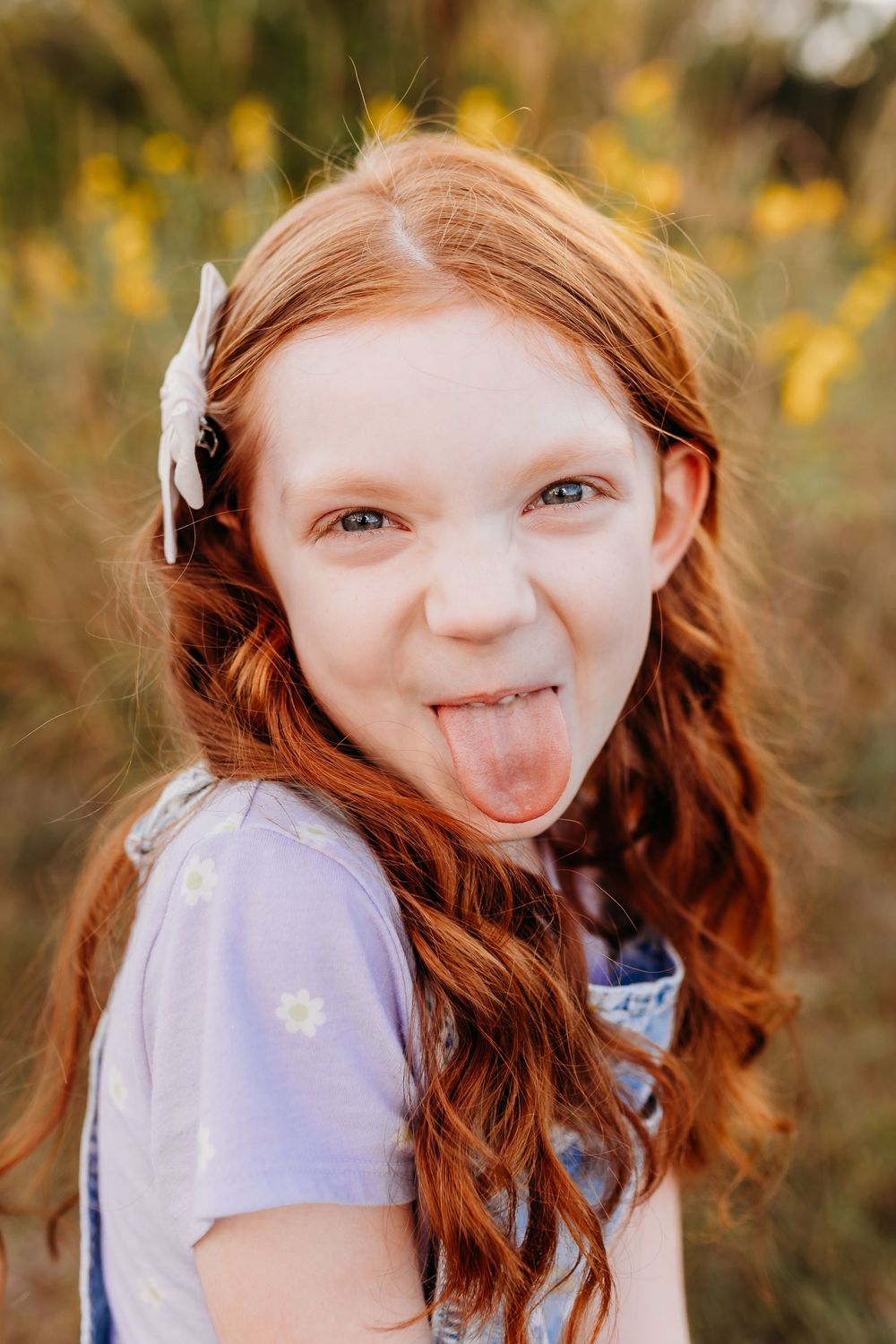 Cute girl sticking out tongue during a portrait. Cincinnati and NKY School and Homeschool Portrait Photographer.