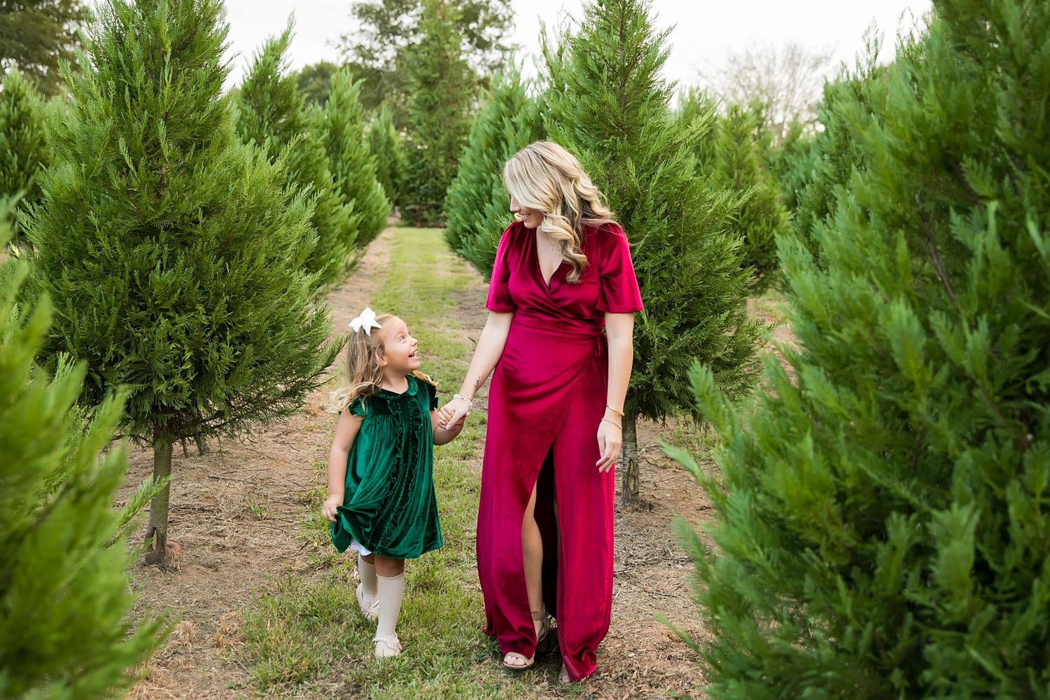 Mom and daughter walk through Windy Hills Christmas Tree Farm in Ethel, LA, photo taken by Baton Rouge Family Photographer.