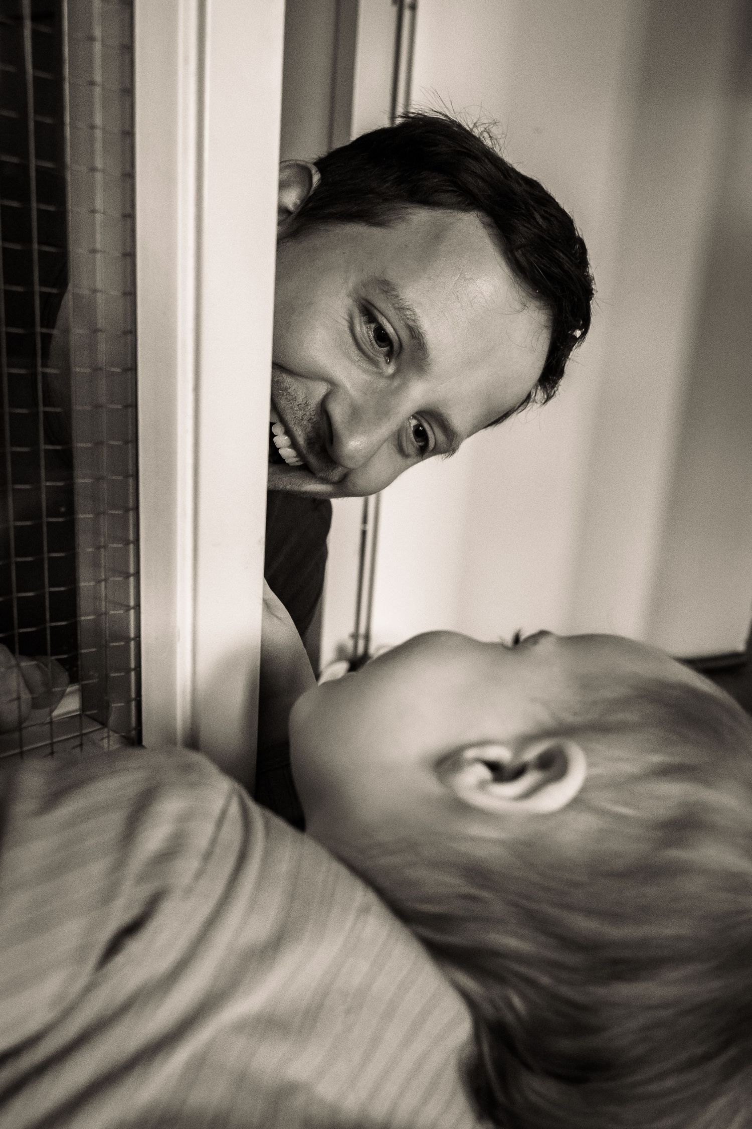 Intimate black and white portrait of tender moment between two people.