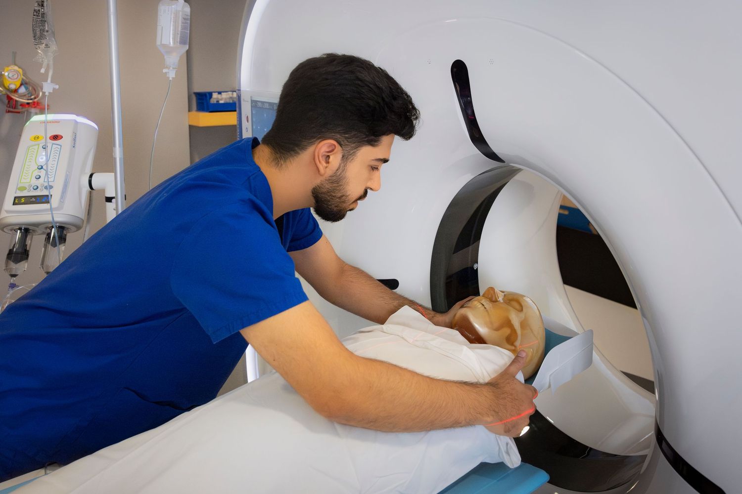 Medical professional adjusts settings on ultrasound imaging equipment in clinical setting.