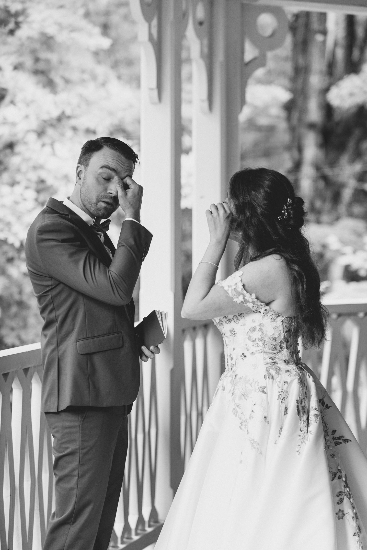 A romantic first look sequence between newlyweds on a white porch with delicate reactions and emotions.