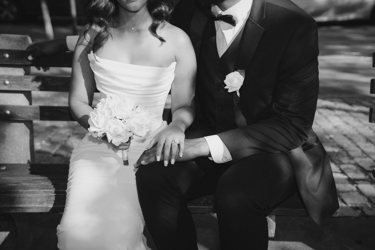 Elegant black and white wedding portrait showing intimate moment between newlyweds.