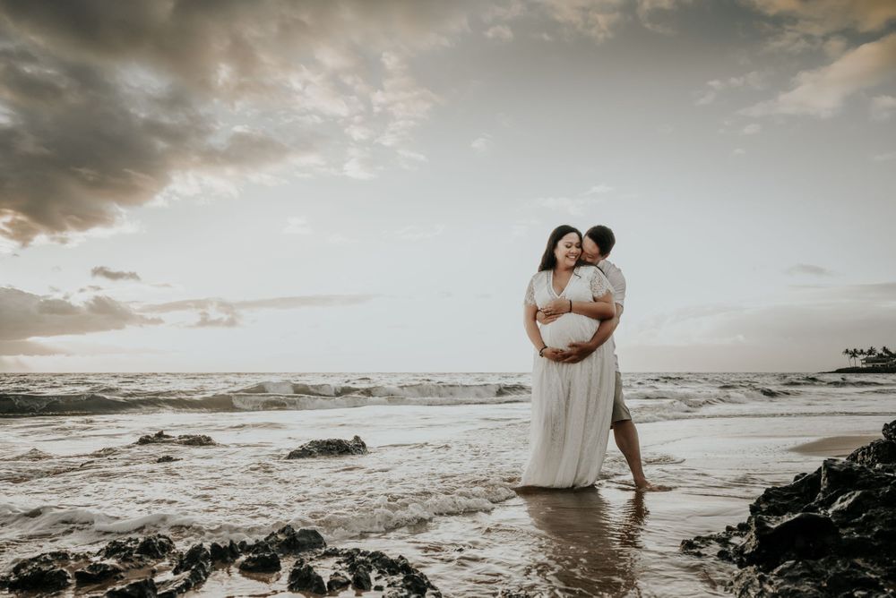 Dramatic sunset beach photography with waves crashing against rocky shore.
