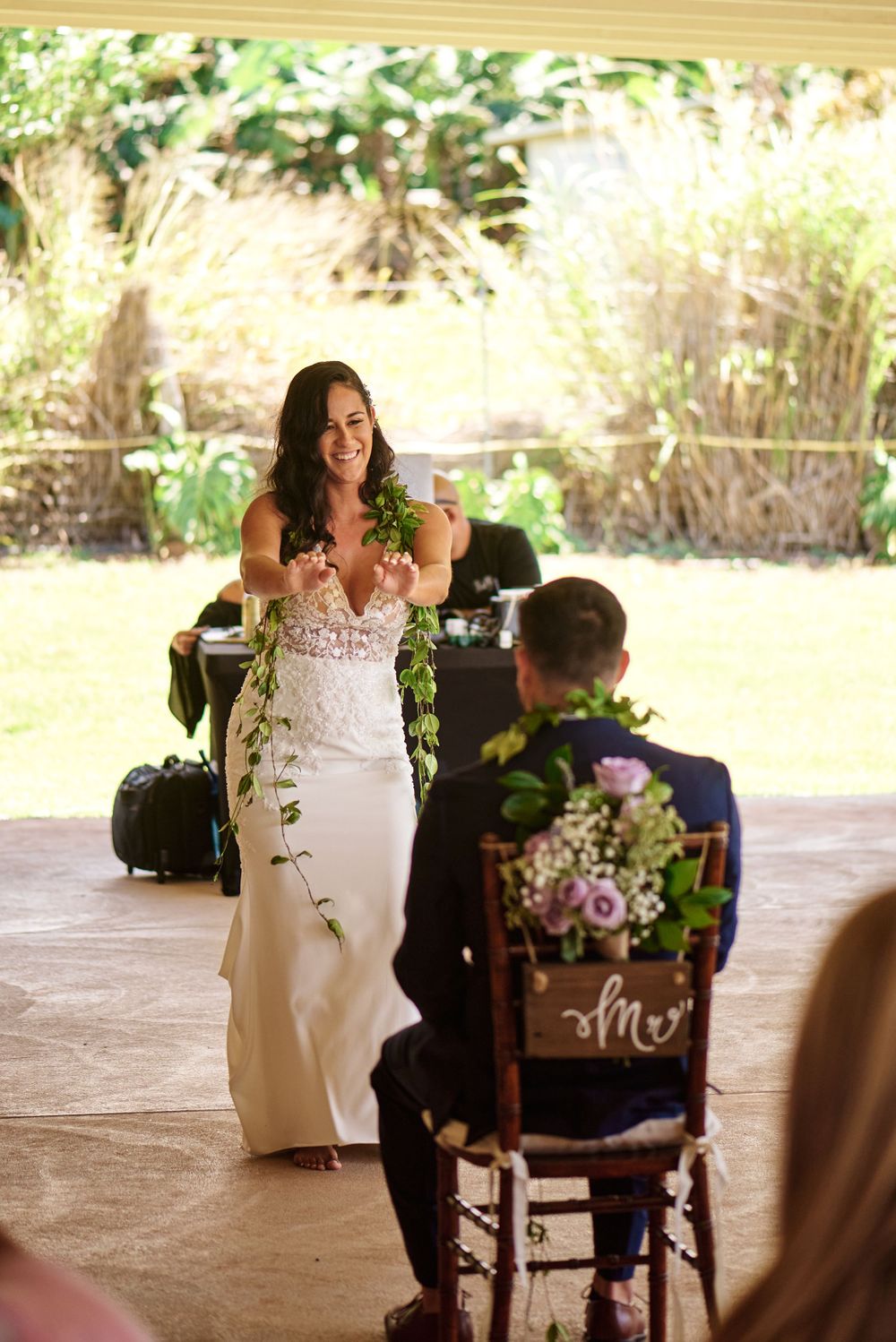 Rustic outdoor celebration space decorated with wooden signs and floral arrangements.