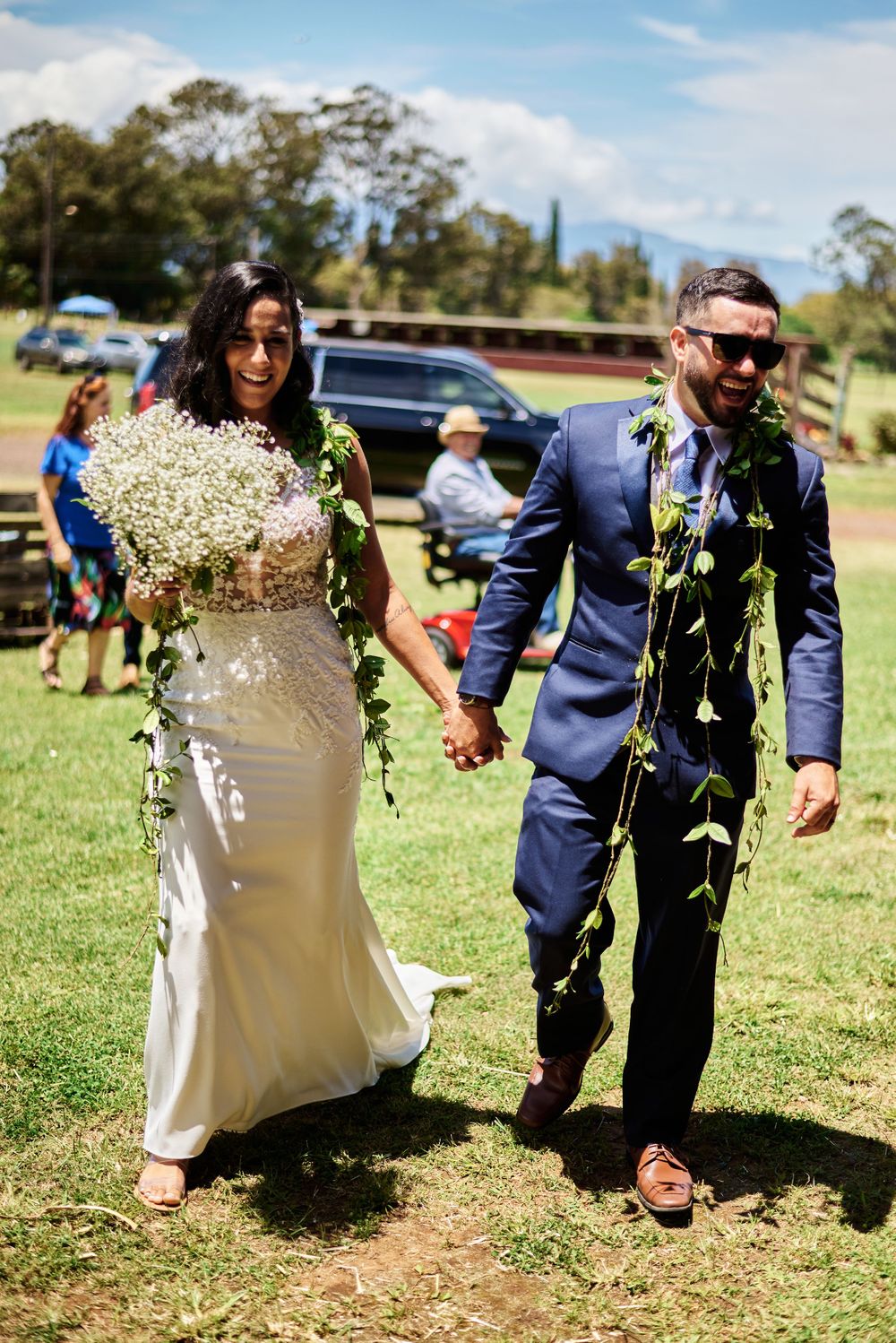 Elegant white dress flowing in the breeze at an outdoor celebration.