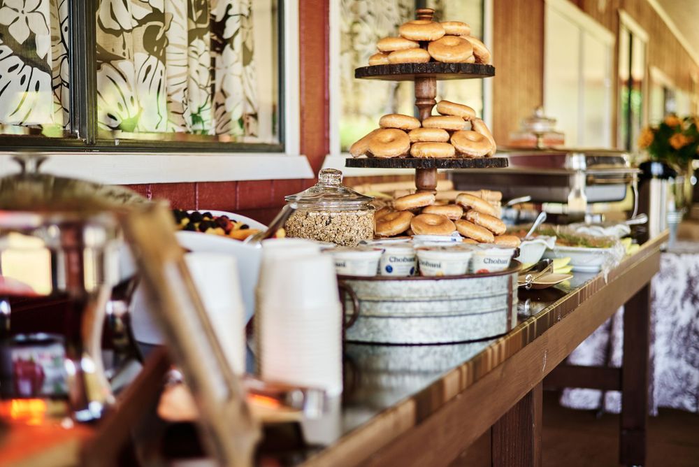 Elegant dessert display featuring tiered cake stands with cookies and pastries at a rustic event.