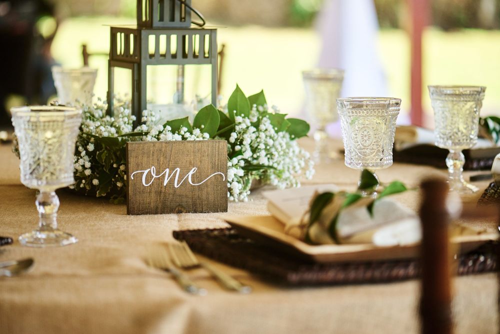 Elegant table setting with crystal glassware and greenery decorations for a special event.