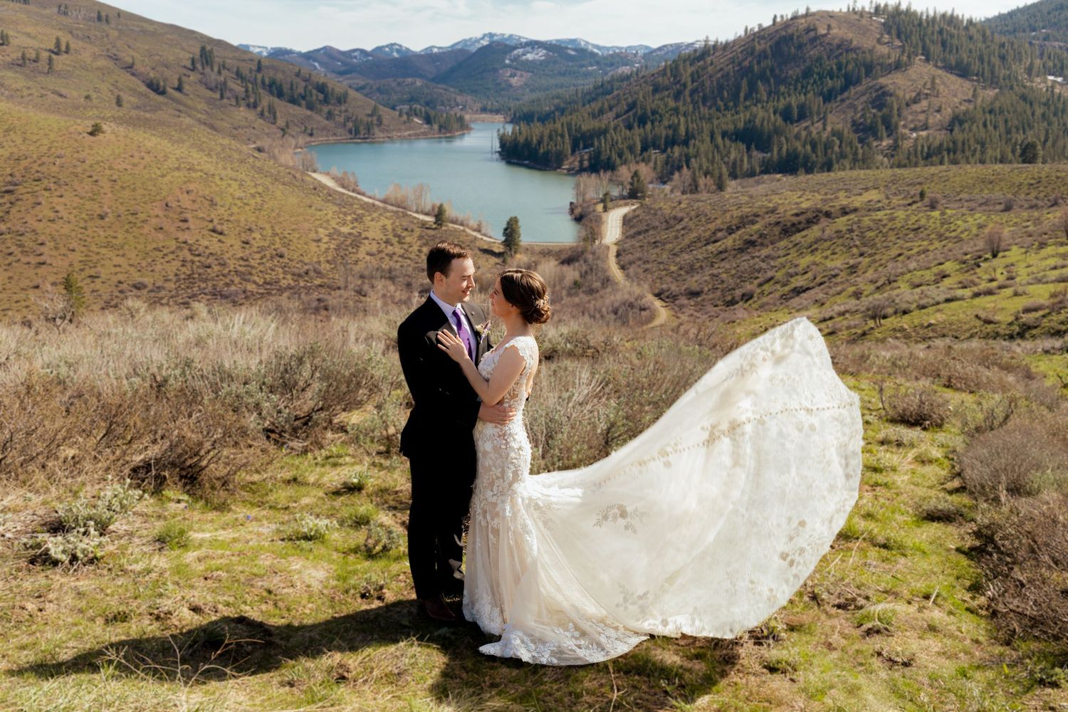 A scenic mountain wedding photoshoot overlooking a stunning lake and rolling hills in the Pacific Northwest.