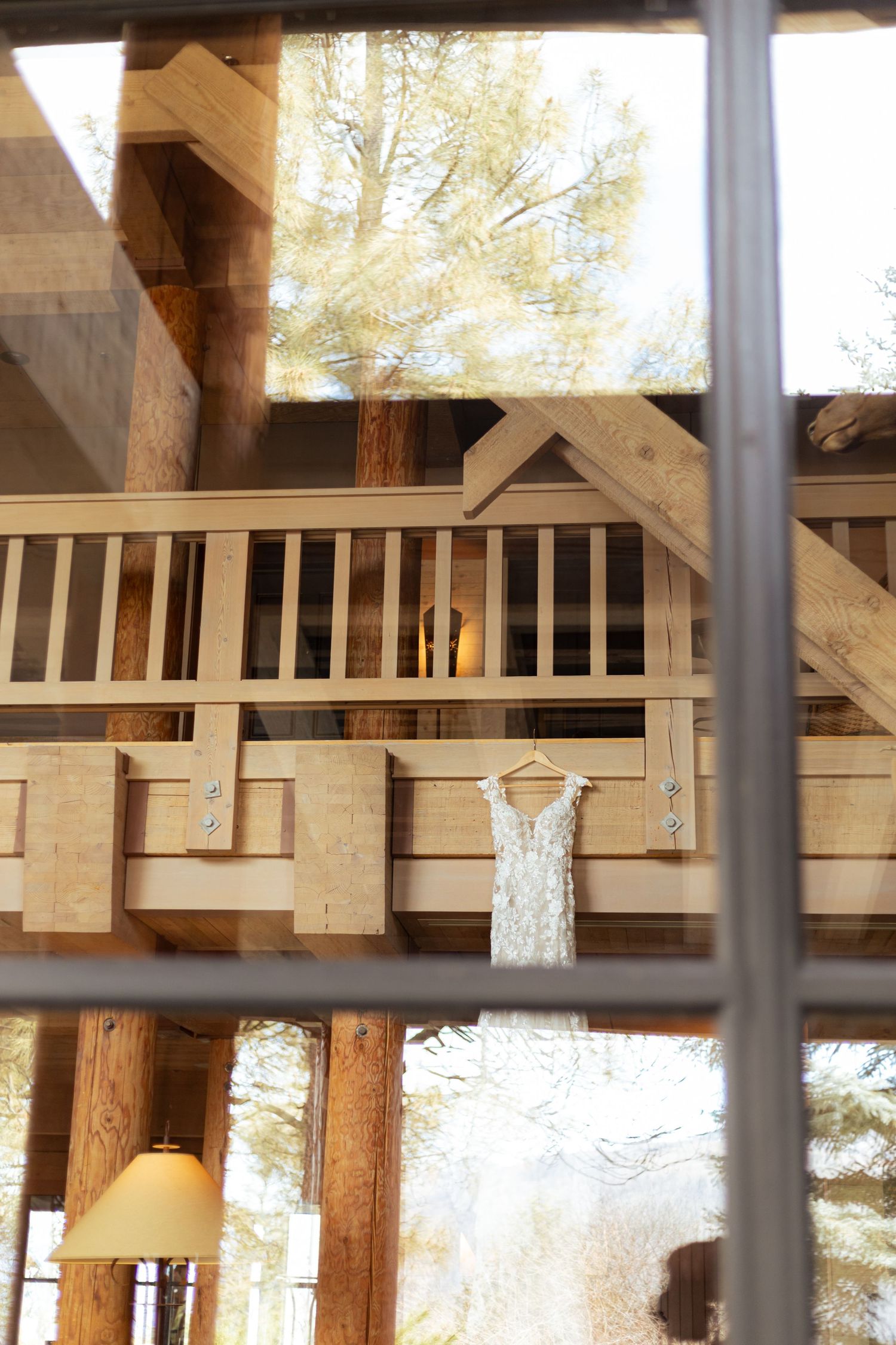 Wooden beams and railings form an architectural detail of a rustic covered porch or deck structure.