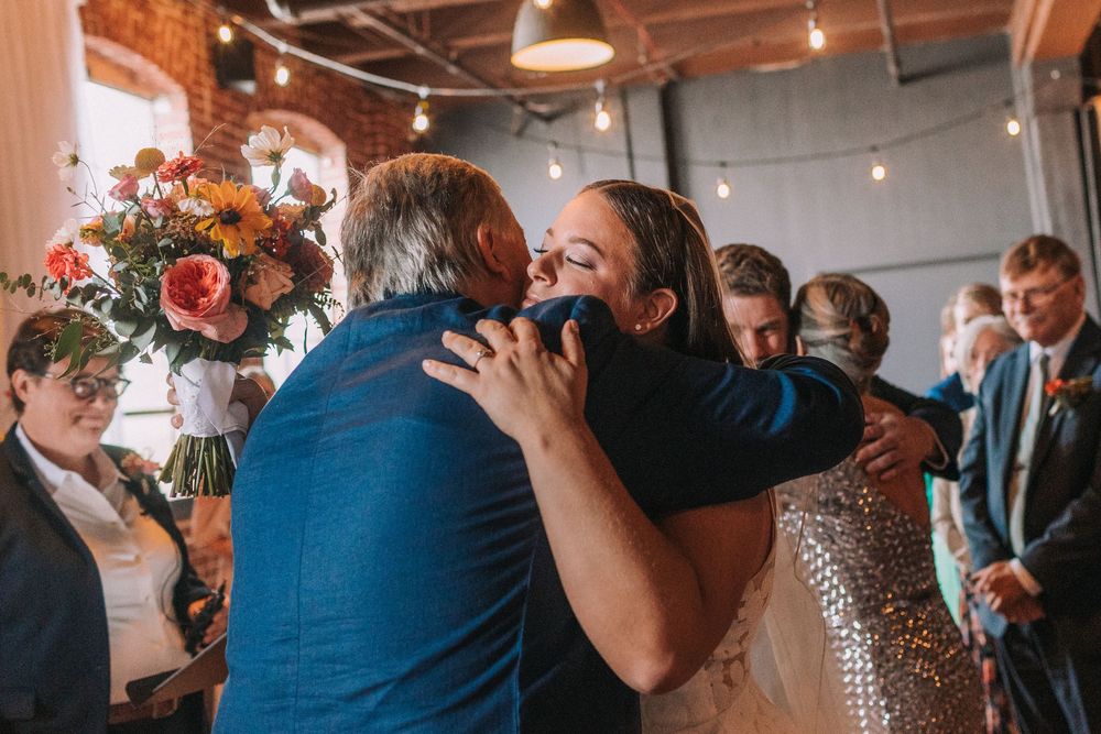 A joyful celebration on a dance floor with guests dancing and having fun at an indoor wedding reception.