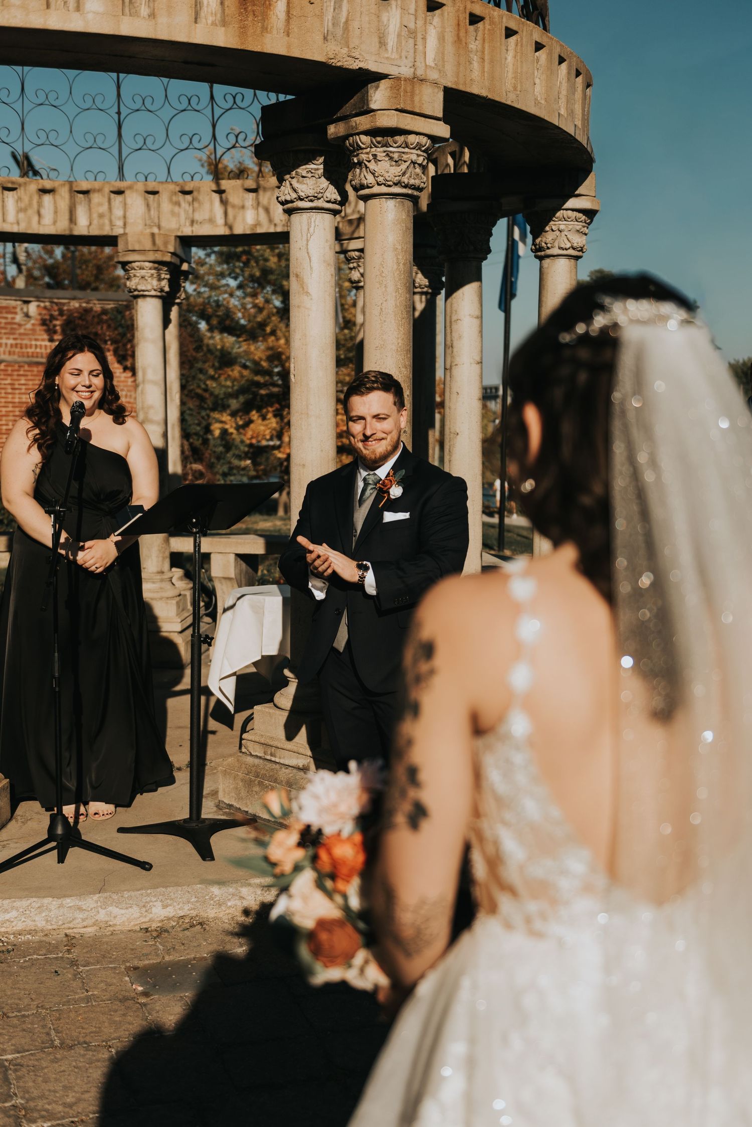 Emotional wedding ceremony reactions captured in a series of candid moments under rustic stone columns at sunset.