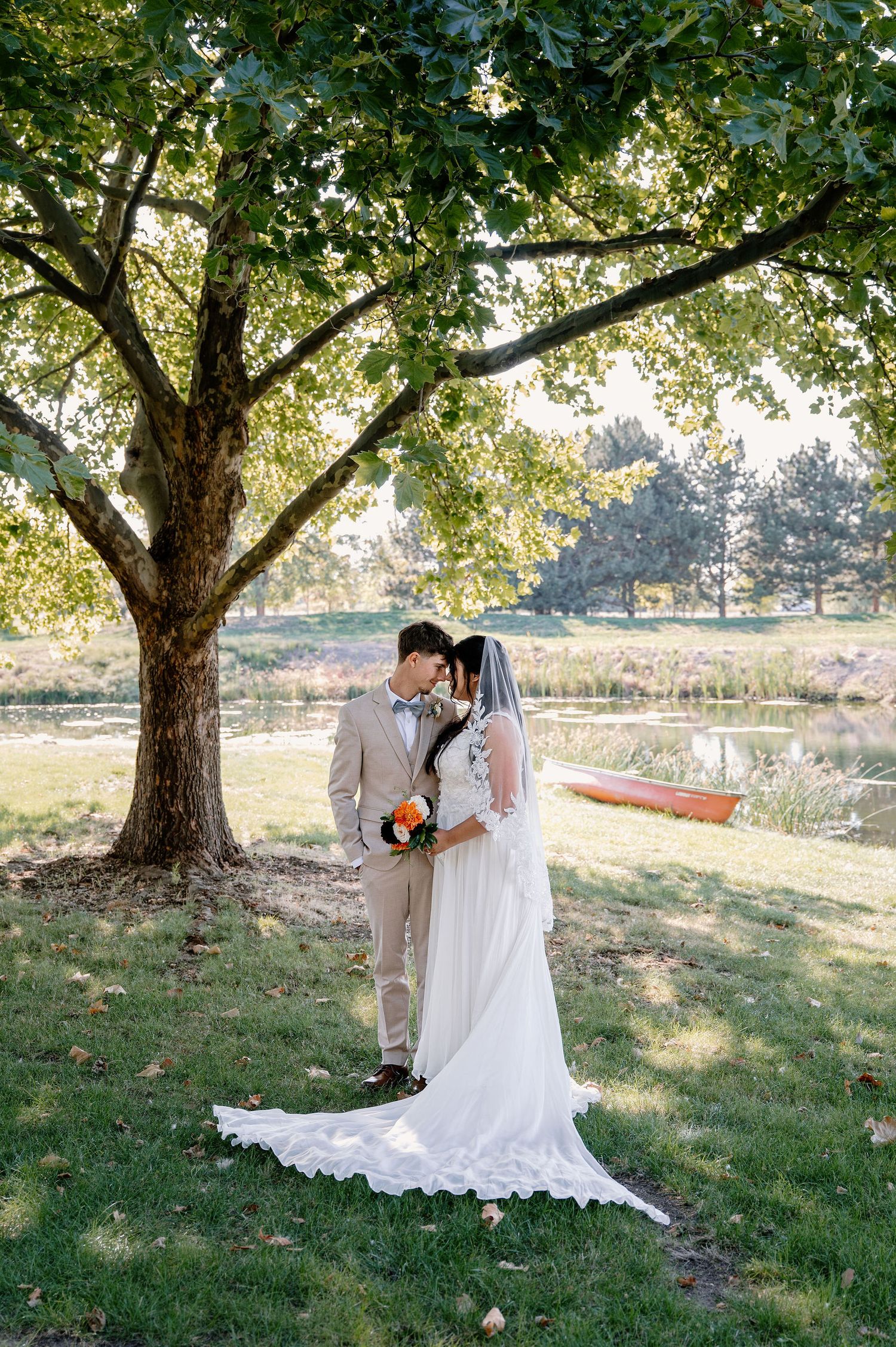 Bride and groom portraits by a pond for their outdoor wedding in Oregon