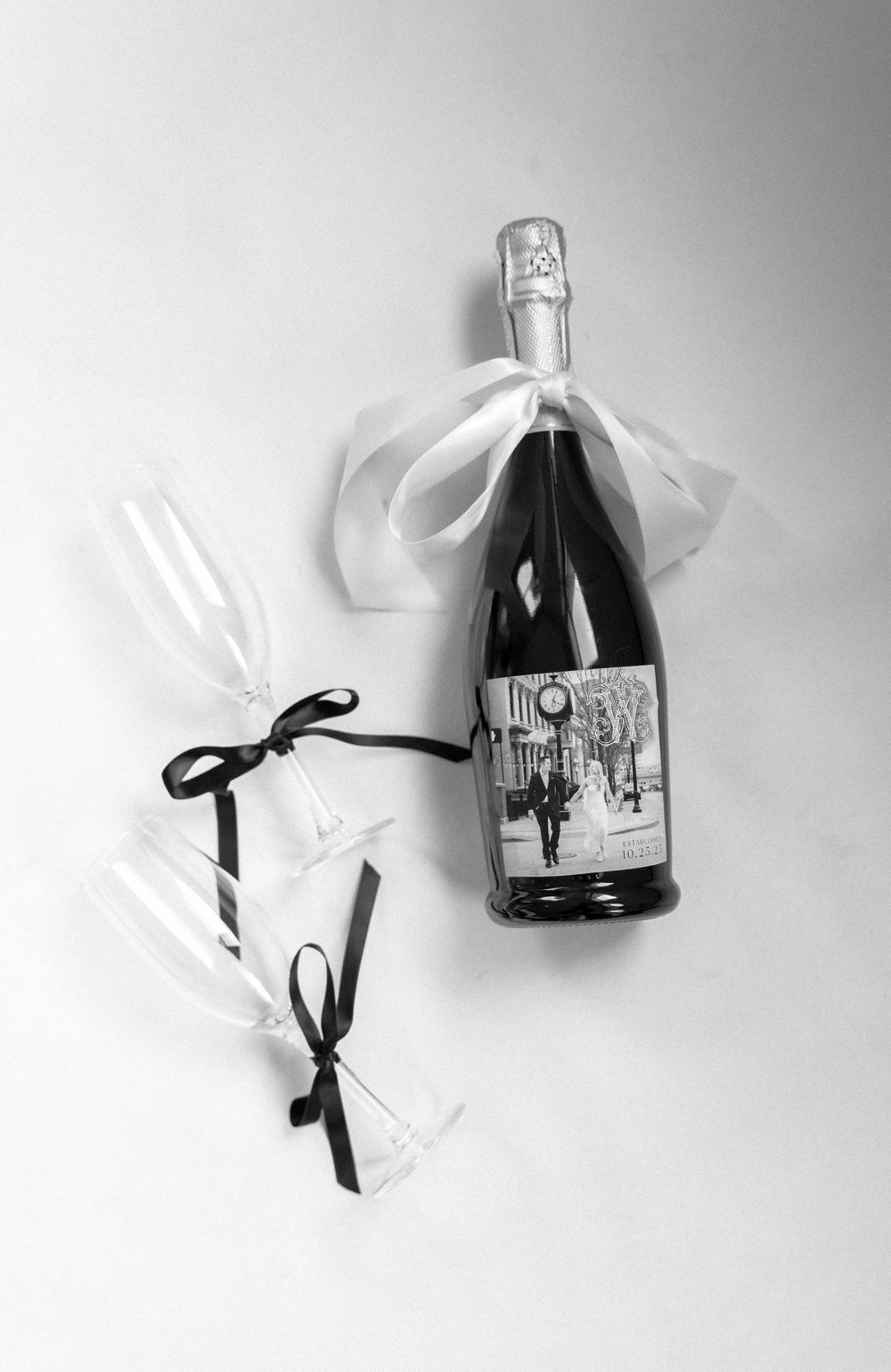 Black and white sequence of a wine bottle falling and breaking on a white background.