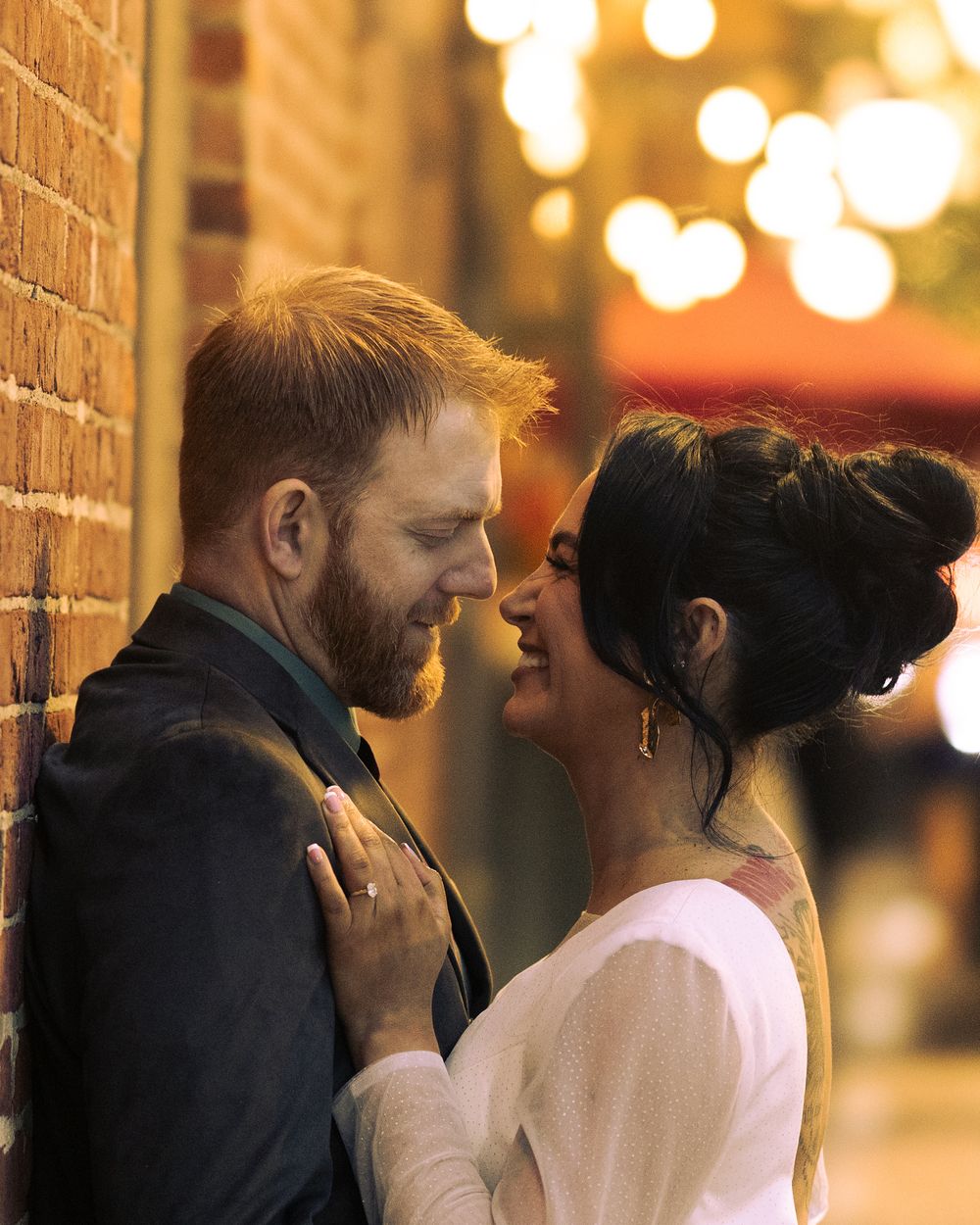 A romantic evening scene with warm lighting and brick wall backdrop. In Old Town Alexandria VA