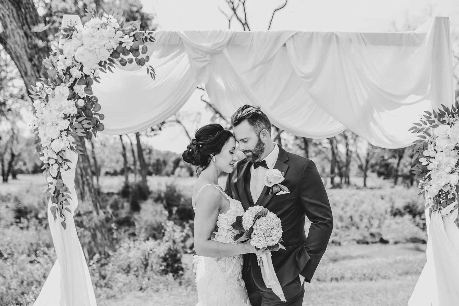 black and white image of newlyweds dipping and kissing during their sparkler exit