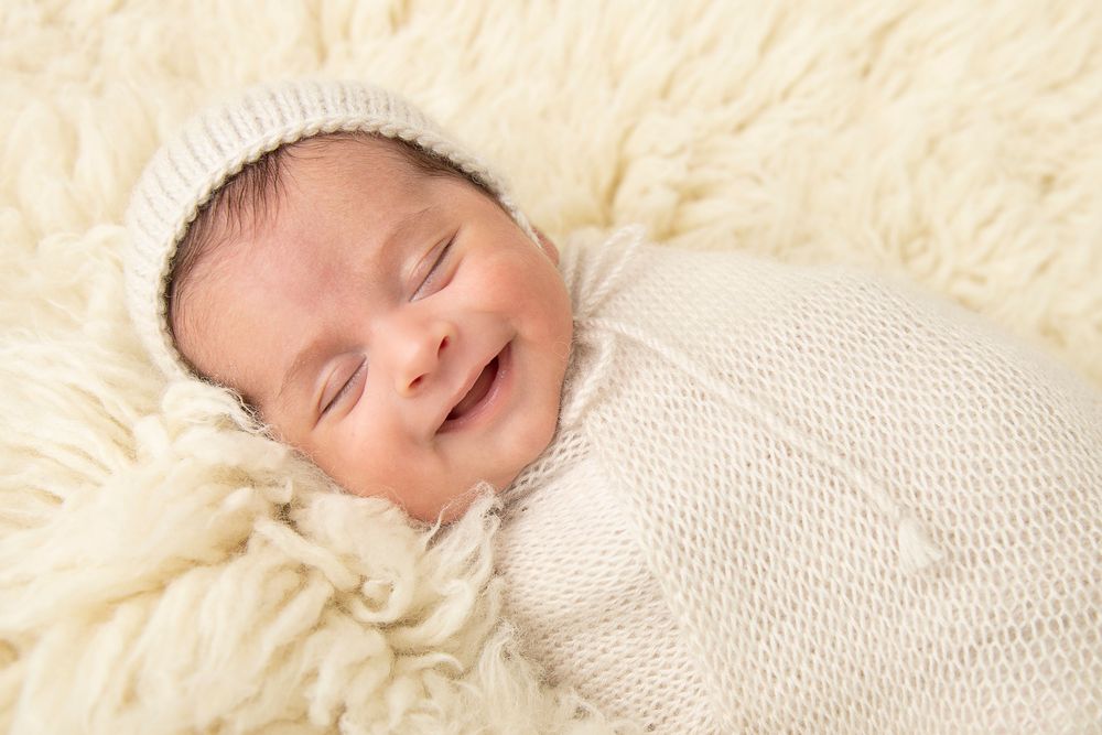 Swaddled baby smiling