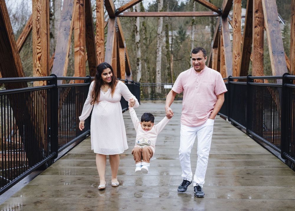 Parents and toddler celebrating a new pregnancy in Bothell. Heartfelt lifestyle photography by Tim Neal.