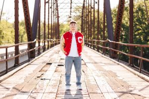 Rustic wooden bridge photography location with sunlight filtering through trees.