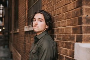 Urban portraits against brick wall showing casual poses and expressions.