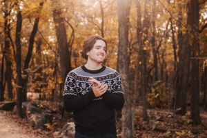 Autumn forest photoshoot with warm golden tones and natural lighting.