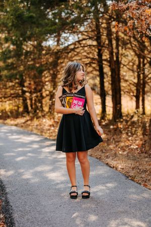 Autumn photoshoot on a winding path through golden-leaved trees.