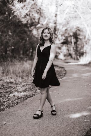 Black and white candid shots capture playful moments on a tree-lined path.